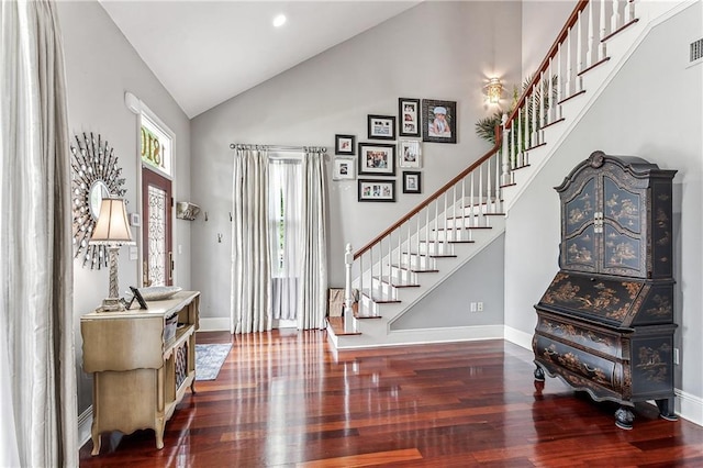 foyer with hardwood / wood-style floors and high vaulted ceiling