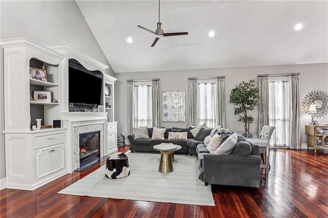 living room with dark hardwood / wood-style floors, high vaulted ceiling, and ceiling fan