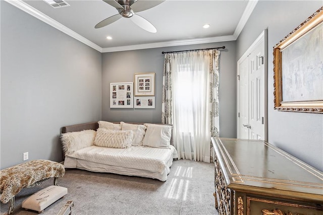 sitting room with carpet floors, ceiling fan, and ornamental molding