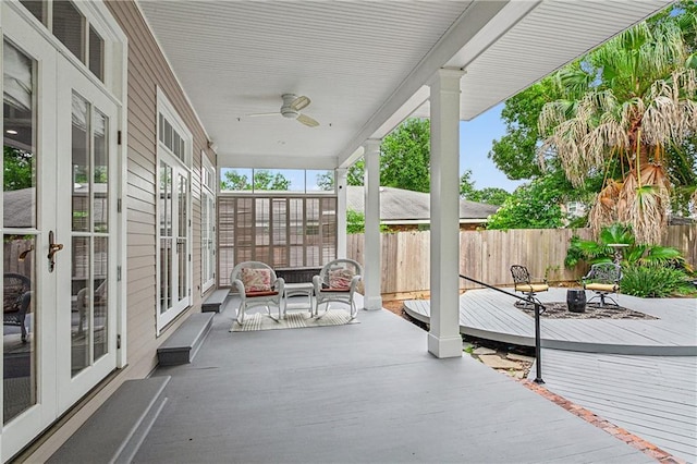 view of patio / terrace featuring ceiling fan, french doors, and a deck