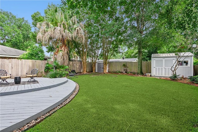 view of yard featuring a wooden deck and a storage unit