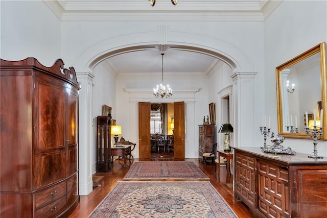 109 Carmel Church Rd, Natchez-Ms, MS 39120 - entryway featuring arched walkways, a chandelier, dark wood-style floors, ornate columns, and crown molding