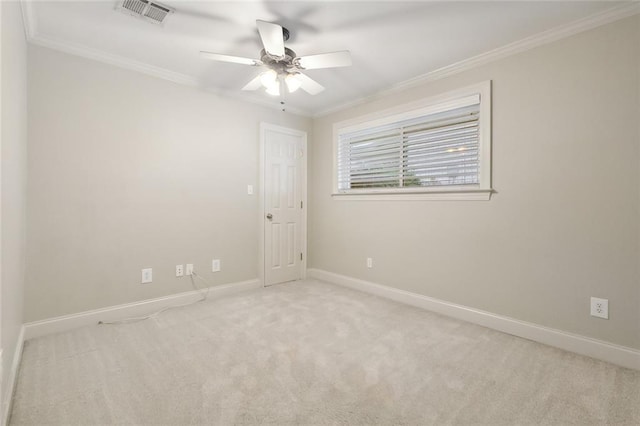 carpeted empty room with ceiling fan and ornamental molding