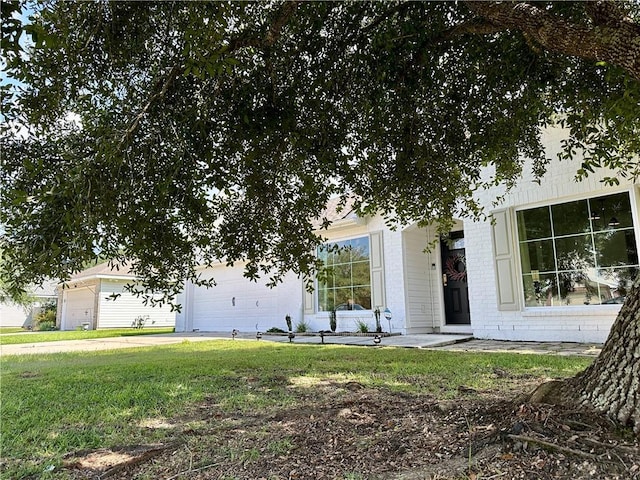 view of front of property with a garage and a front lawn