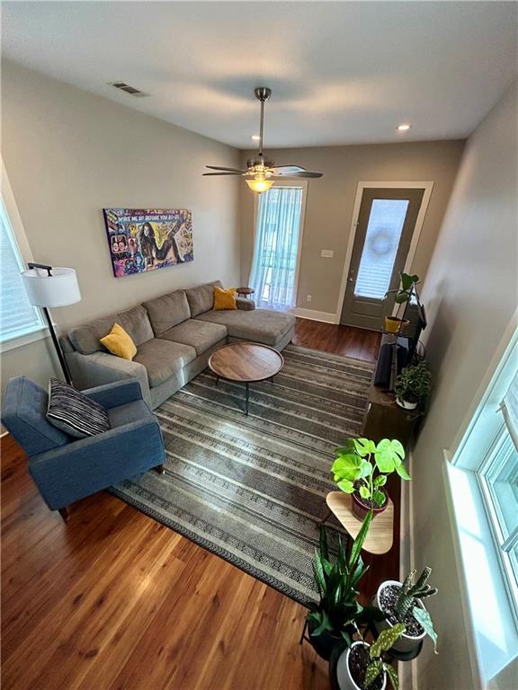 living room with hardwood / wood-style flooring and ceiling fan