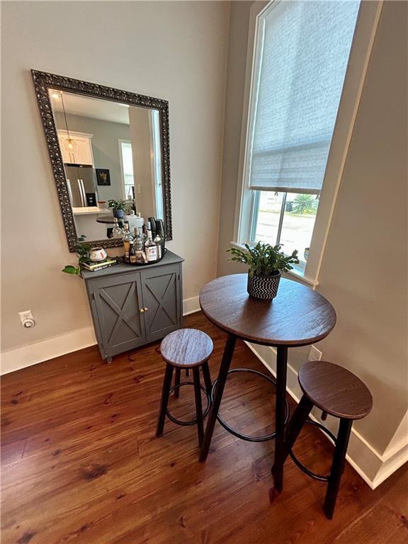 dining space featuring dark hardwood / wood-style floors