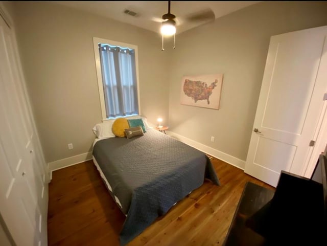 bedroom with ceiling fan and dark hardwood / wood-style flooring