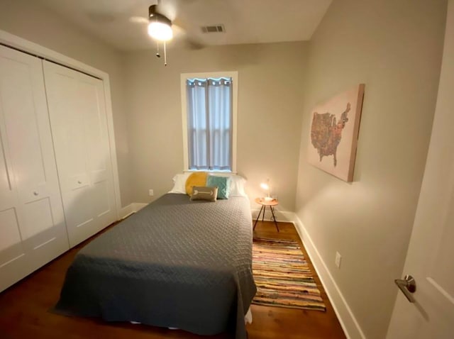 bedroom featuring a closet, dark wood-type flooring, and ceiling fan