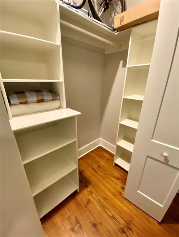 walk in closet featuring hardwood / wood-style floors