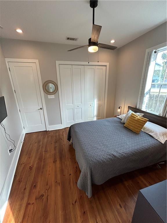 bedroom featuring ceiling fan and dark wood-type flooring