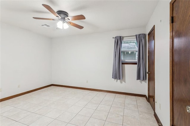 unfurnished room with ceiling fan and light tile patterned floors