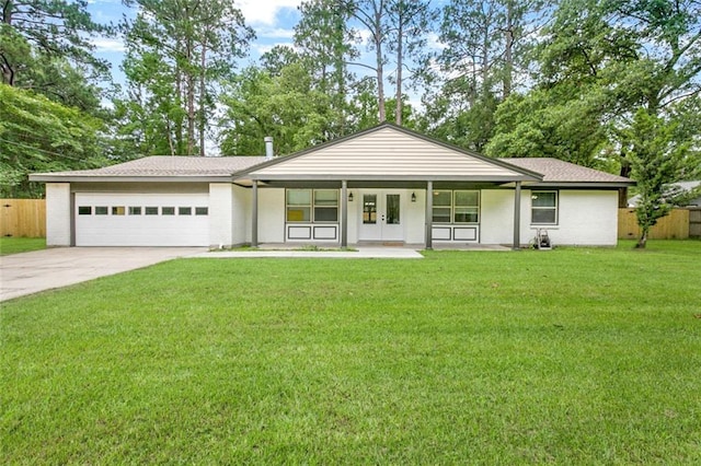 view of front facade with brick siding, concrete driveway, an attached garage, fence, and a front lawn