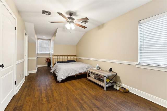 bedroom with multiple windows, ceiling fan, dark hardwood / wood-style flooring, and lofted ceiling