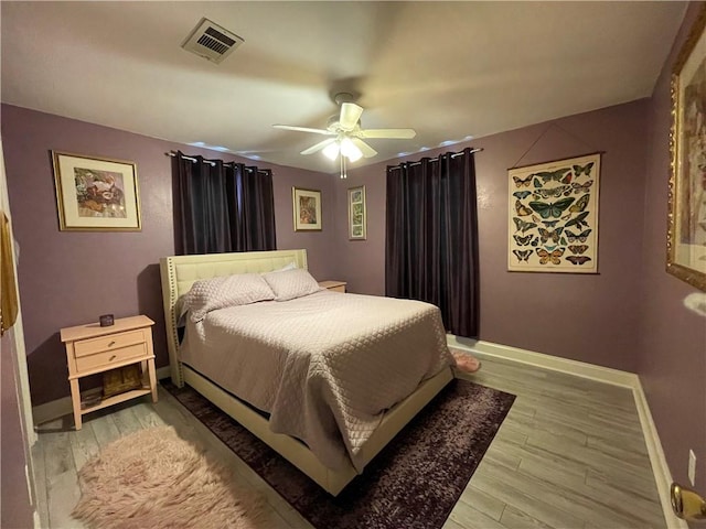 bedroom with ceiling fan and light hardwood / wood-style flooring