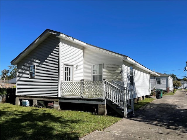 view of side of property with a lawn