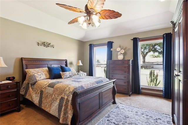 bedroom with light colored carpet, multiple windows, and ceiling fan