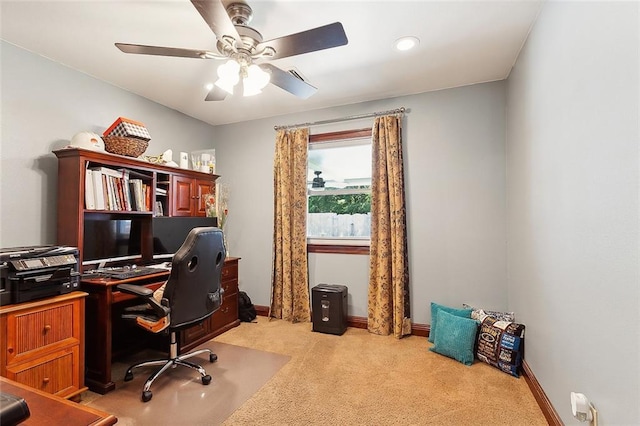 office area featuring light carpet and ceiling fan