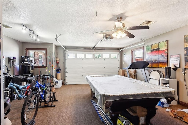 garage featuring ceiling fan and a garage door opener