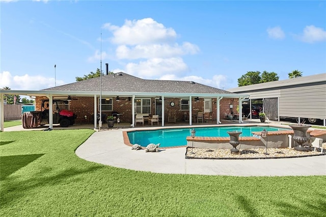 view of pool featuring a patio area, ceiling fan, and a yard