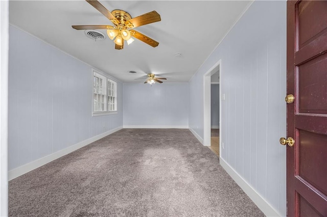 carpeted spare room featuring ceiling fan and crown molding