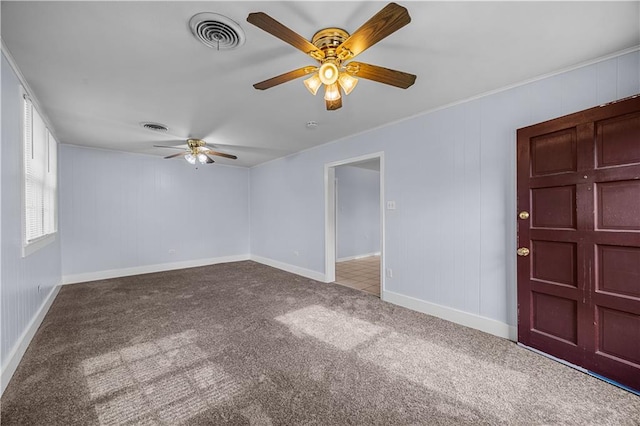 unfurnished room with ceiling fan and carpet