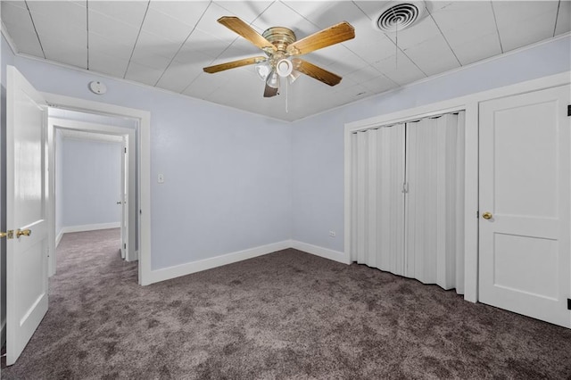 unfurnished bedroom featuring ceiling fan and dark colored carpet