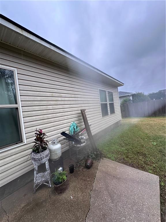 view of property exterior with a patio area and a yard