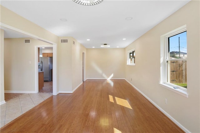 spare room featuring light hardwood / wood-style flooring