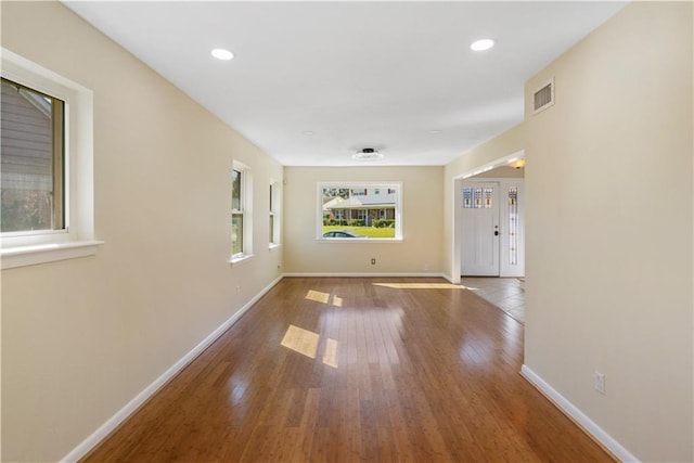 hallway with hardwood / wood-style flooring