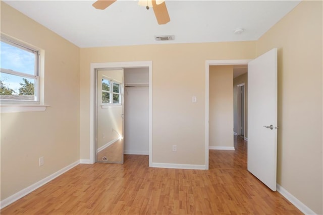 unfurnished bedroom featuring ceiling fan, a closet, and light hardwood / wood-style floors