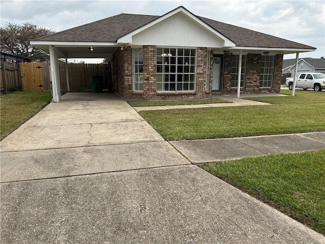 ranch-style house featuring a carport and a front lawn