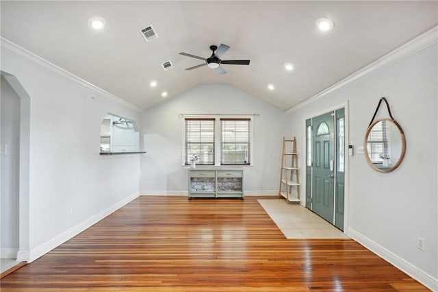 entrance foyer featuring ceiling fan, wood-type flooring, crown molding, and vaulted ceiling