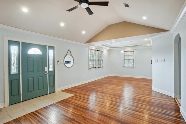 entryway featuring ceiling fan, ornamental molding, lofted ceiling, and light wood-type flooring