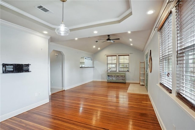 unfurnished living room featuring hardwood / wood-style flooring, ceiling fan, ornamental molding, and vaulted ceiling