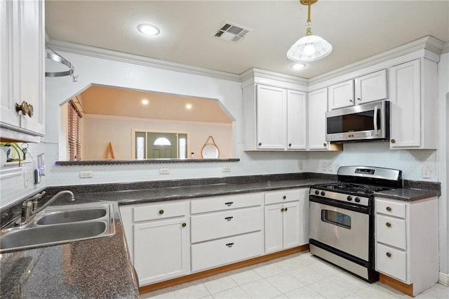 kitchen with stainless steel appliances, crown molding, sink, pendant lighting, and white cabinetry