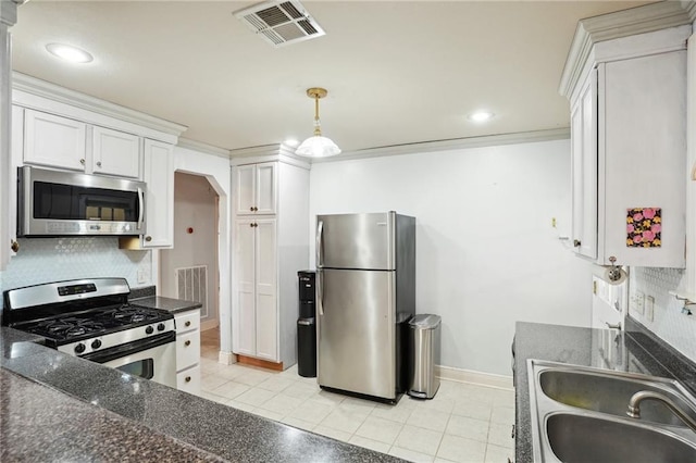 kitchen with appliances with stainless steel finishes, backsplash, crown molding, sink, and white cabinets