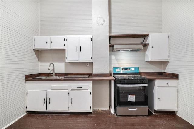 kitchen with white cabinets, stainless steel gas stove, dark hardwood / wood-style floors, and sink