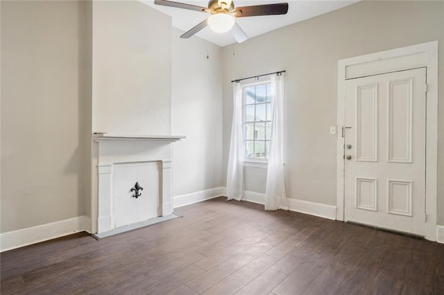 interior space with ceiling fan and dark hardwood / wood-style flooring