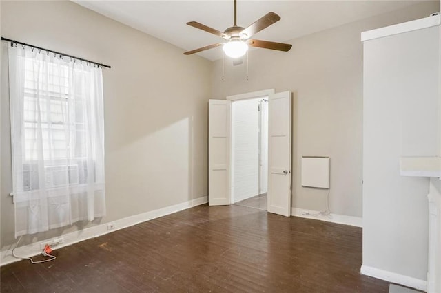 spare room with ceiling fan and dark hardwood / wood-style flooring