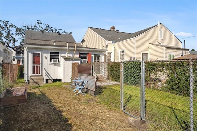 back of property with cooling unit and a yard