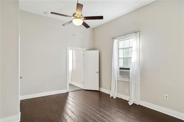 empty room with dark hardwood / wood-style floors and ceiling fan