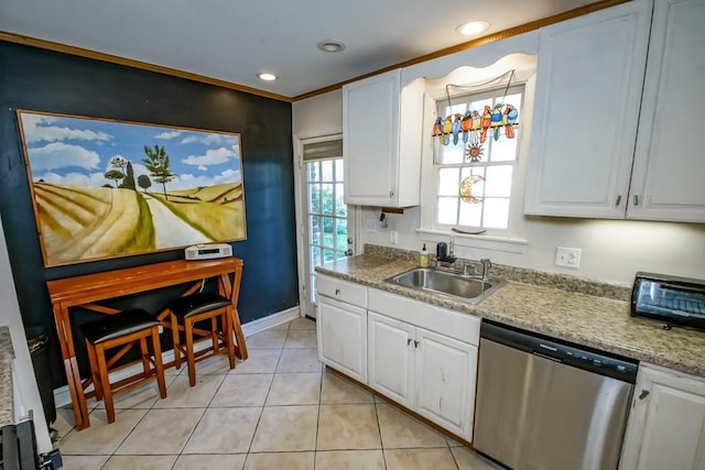 kitchen featuring dishwasher, sink, white cabinetry, and light tile patterned flooring