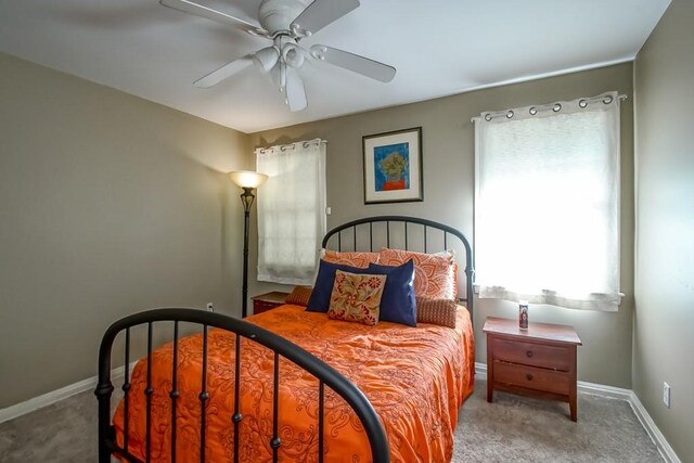 bedroom with ceiling fan and light colored carpet