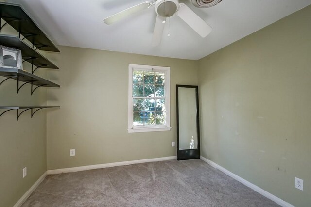 unfurnished room featuring ceiling fan and light carpet