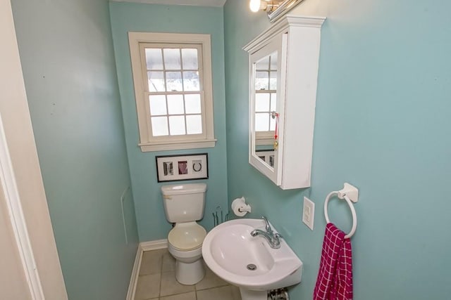 bathroom featuring tile patterned flooring, toilet, and sink