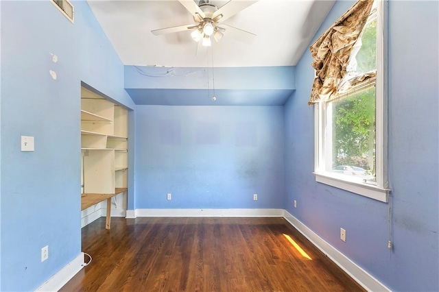 unfurnished room featuring ceiling fan and dark wood-type flooring