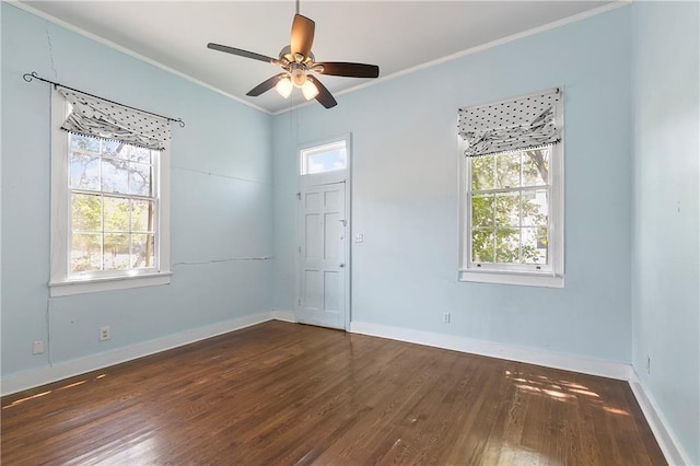 empty room with dark wood-type flooring, ceiling fan, and ornamental molding