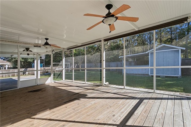 unfurnished sunroom with ceiling fan