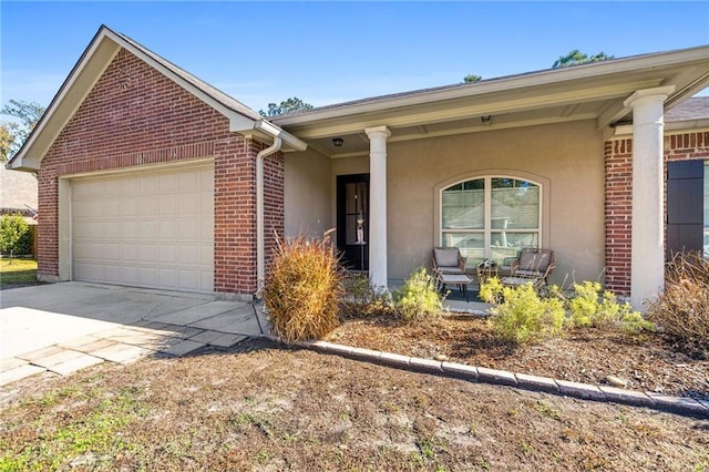 single story home featuring a porch and a garage