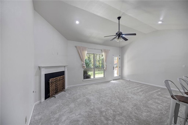 unfurnished living room with carpet floors, vaulted ceiling, and ceiling fan